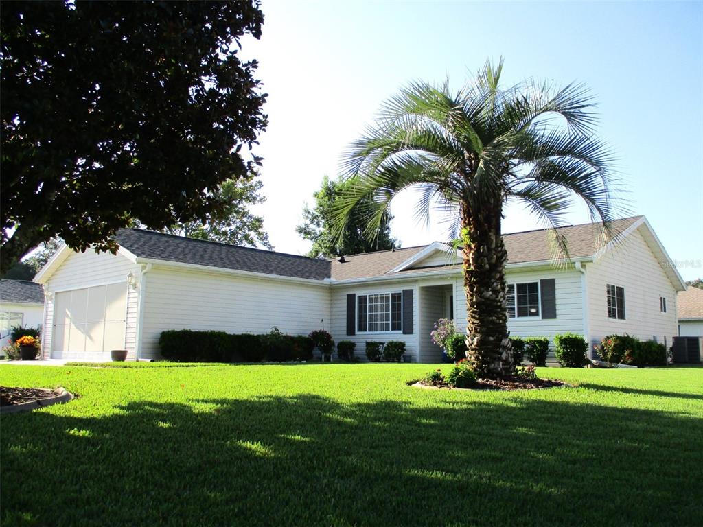 11352 Southwest 138th Lane Dunnellon, FL 34432 - Photo 1 of 1 a front view of a house with a garden and yard