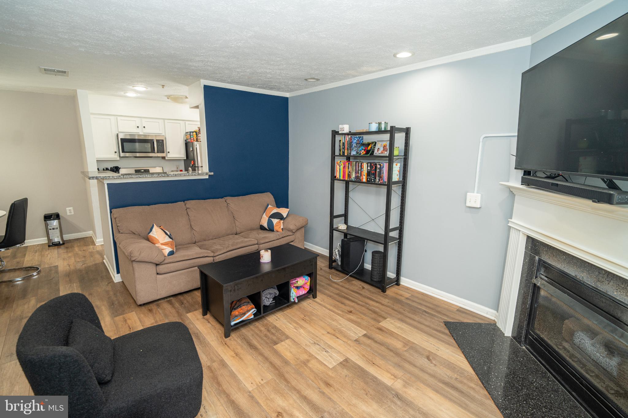 8911 Town Center Circle, Unit 4102 Upper Marlboro, MD 20774 - Photo 11 of 16 a bedroom with furniture and a flat screen tv