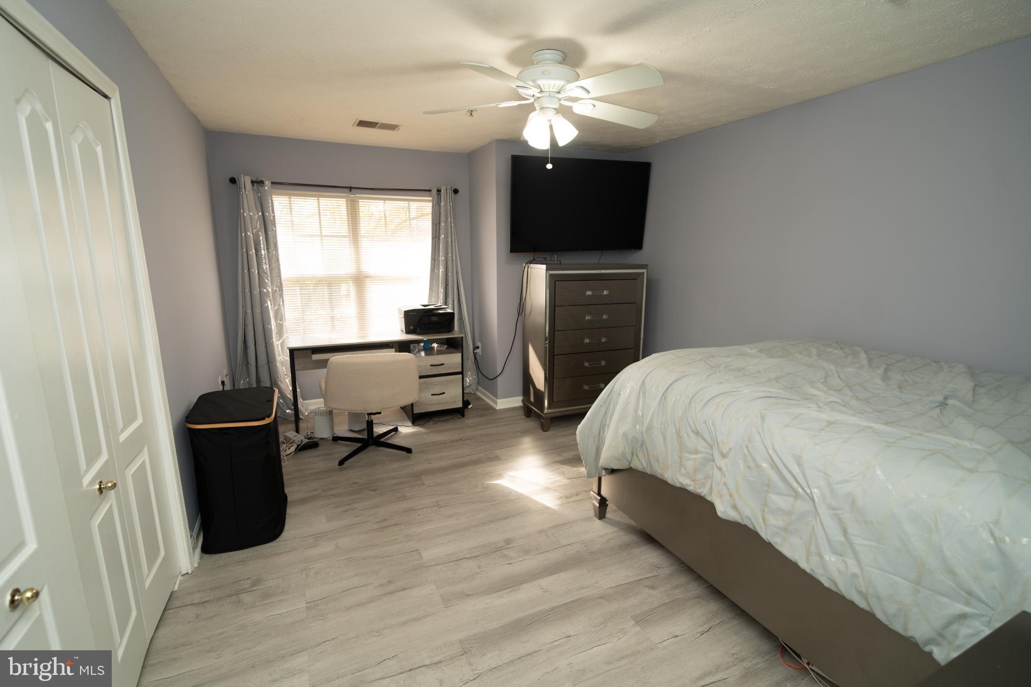 8911 Town Center Circle, Unit 4102 Upper Marlboro, MD 20774 - Photo 14 of 16 a bed room with a bed and a television