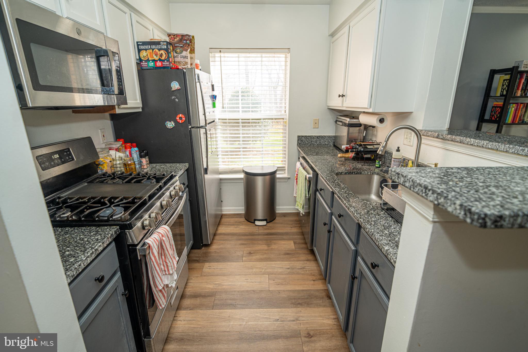 8911 Town Center Circle, Unit 4102 Upper Marlboro, MD 20774 - Photo 2 of 16 a kitchen with stainless steel appliances granite countertop a stove top oven a sink dishwasher and a refrigerator