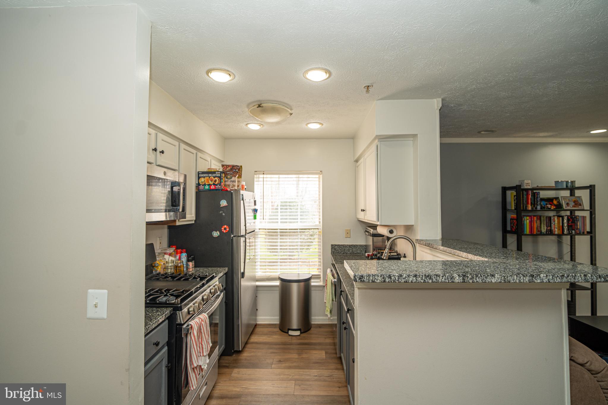 8911 Town Center Circle, Unit 4102 Upper Marlboro, MD 20774 - Photo 3 of 16 a kitchen with stainless steel appliances granite countertop a sink stove and refrigerator