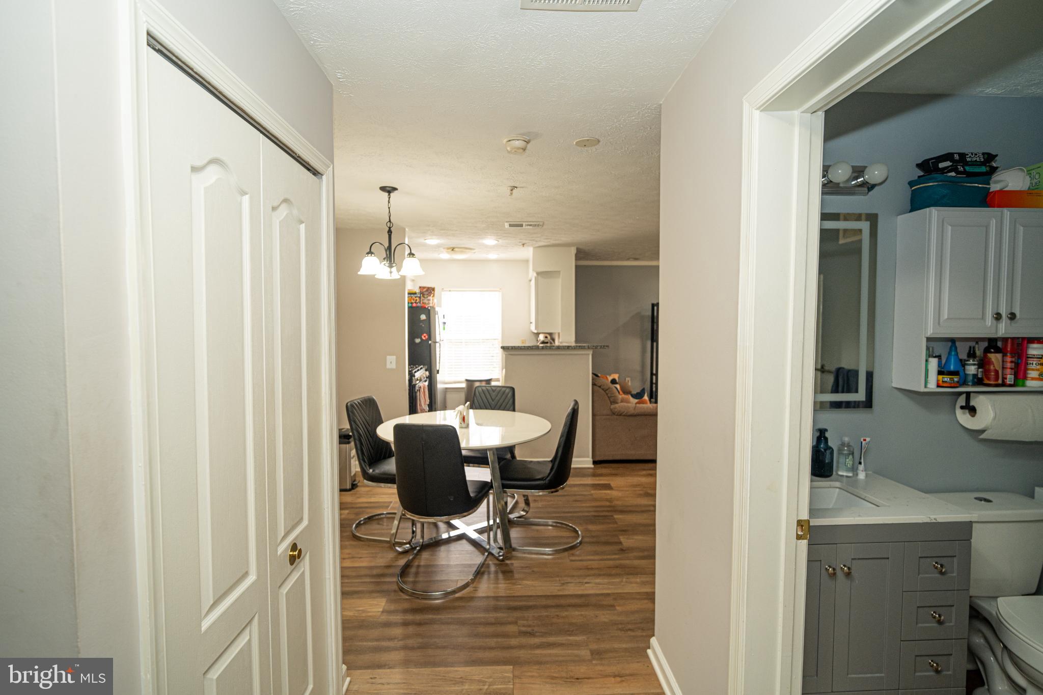 8911 Town Center Circle, Unit 4102 Upper Marlboro, MD 20774 - Photo 4 of 16 a view of kitchen with dining table and chairs