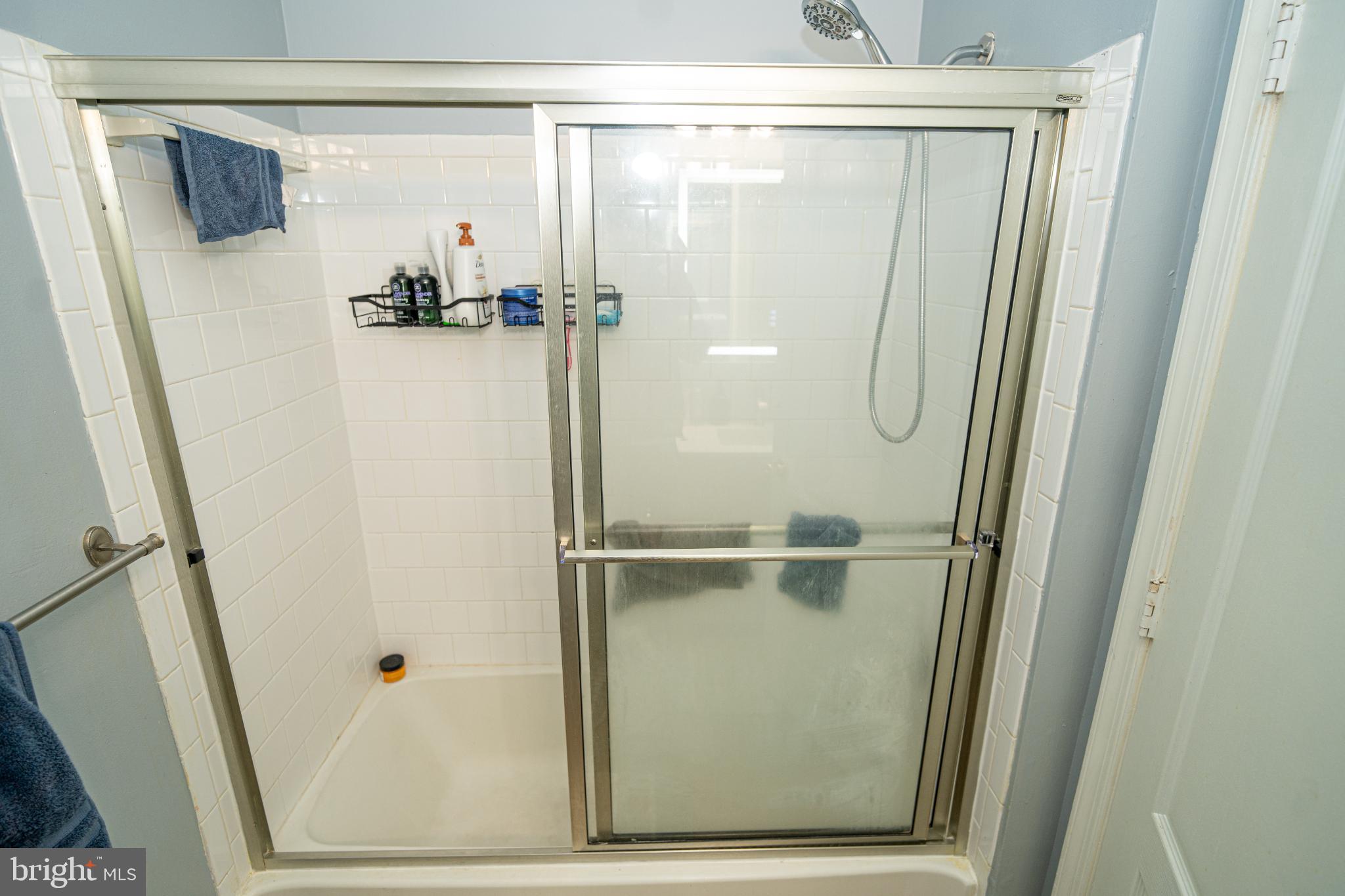 8911 Town Center Circle, Unit 4102 Upper Marlboro, MD 20774 - Photo 6 of 16 a bathroom with a glass shower door