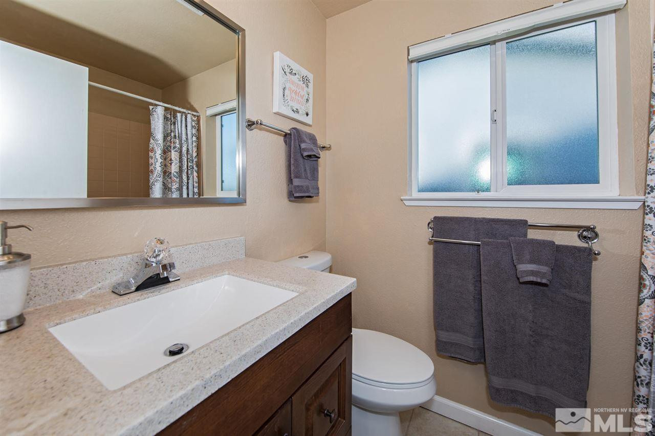 2910 Severn Drive Reno, NV 89503 - Photo 13 of 23 a bathroom with a sink a toilet and a mirror