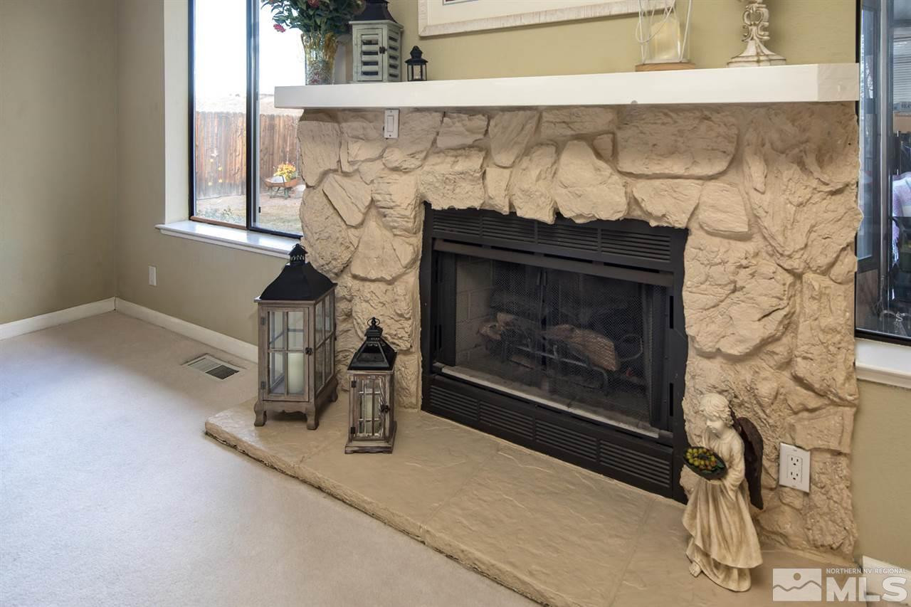 2910 Severn Drive Reno, NV 89503 - Photo 4 of 23 a fireplace with a clock on top of it