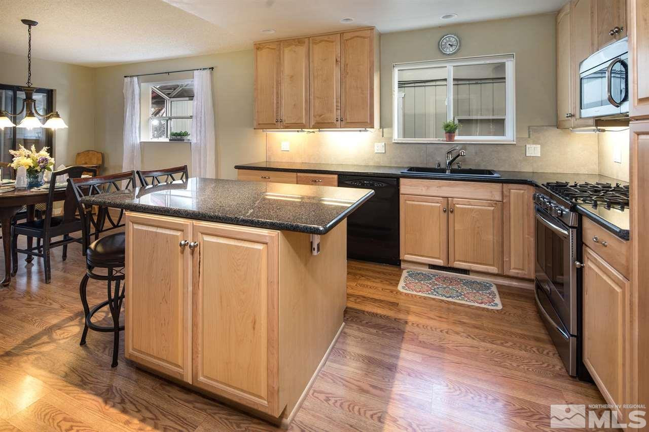 2910 Severn Drive Reno, NV 89503 - Photo 5 of 23 a kitchen with granite countertop a stove a sink and a refrigerator