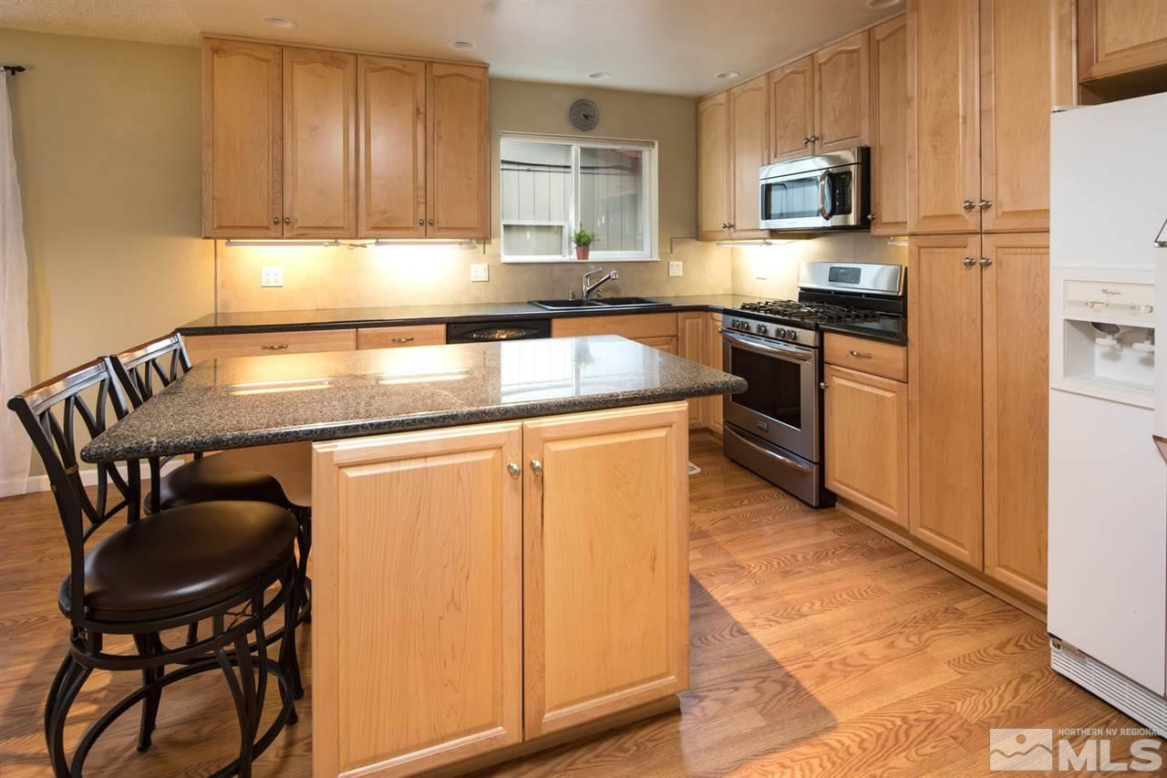 2910 Severn Drive Reno, NV 89503 - Photo 7 of 23 a kitchen with stainless steel appliances granite countertop a stove a sink a microwave and a refrigerator