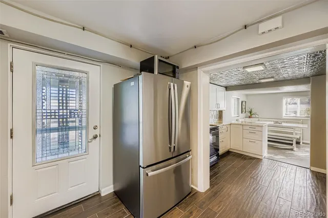 a kitchen with stainless steel appliances a refrigerator and cabinets