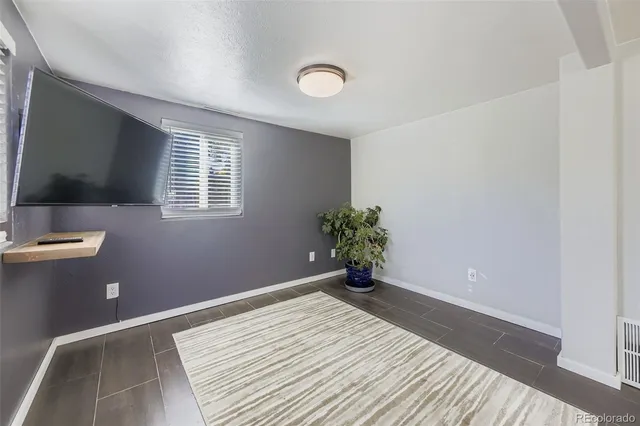 a view of a livingroom with wooden floor and a window