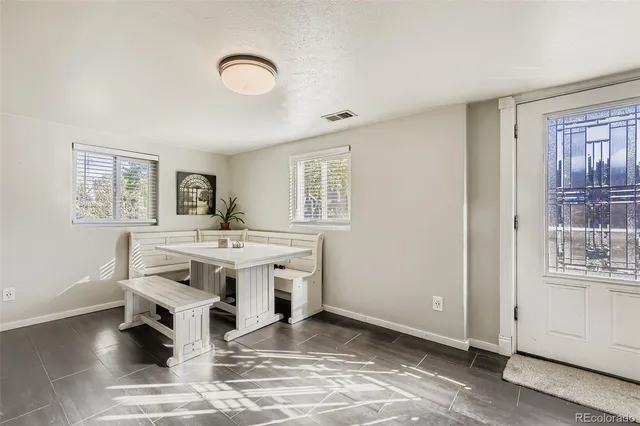 a view of living room with kitchen island stainless steel appliances wooden floor and window