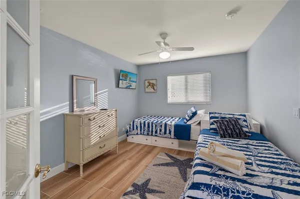 a bedroom with furniture and wooden floor