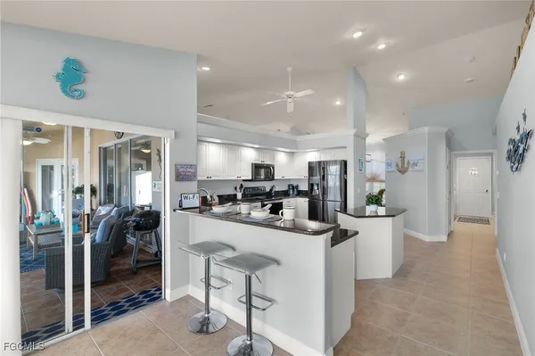 a kitchen with a sink a counter top stainless steel appliances and cabinets