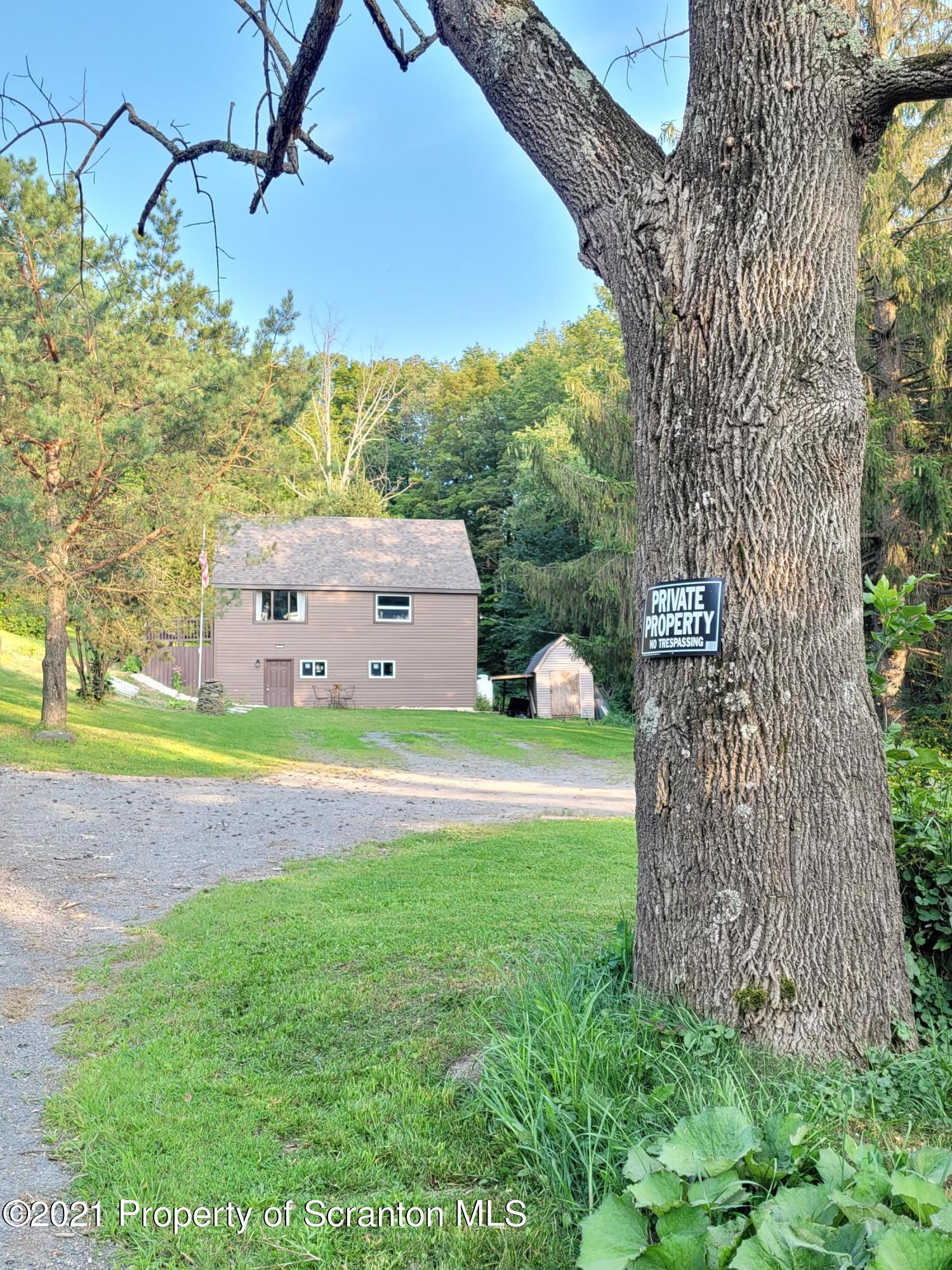 390 Post Pond Road Montrose, PA 18801 - Photo 29 of 45 a backyard of a house with lots of green space