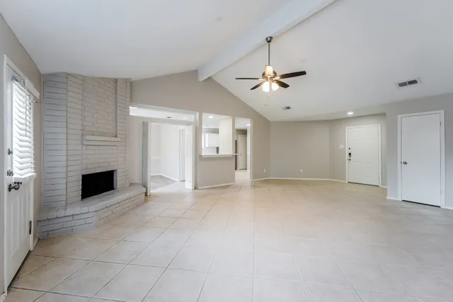 a view of an empty room with a fireplace