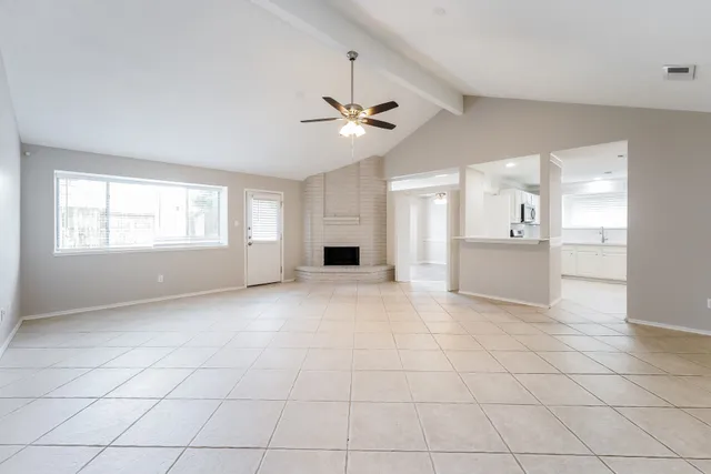 a view of an empty room with a kitchen