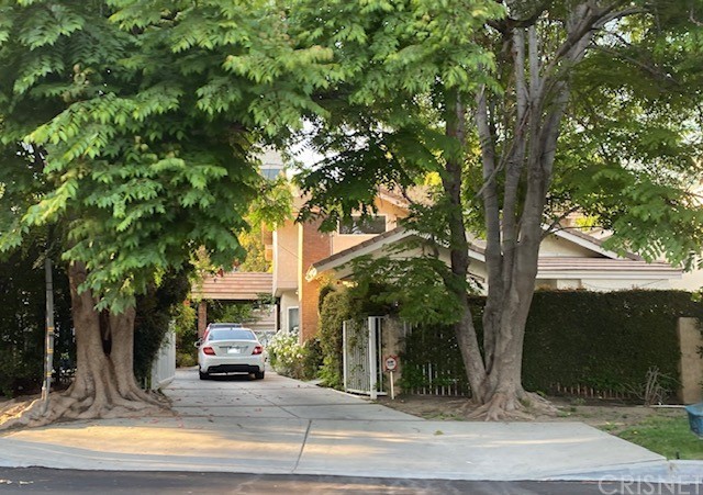 a view of a house with a tree in front
