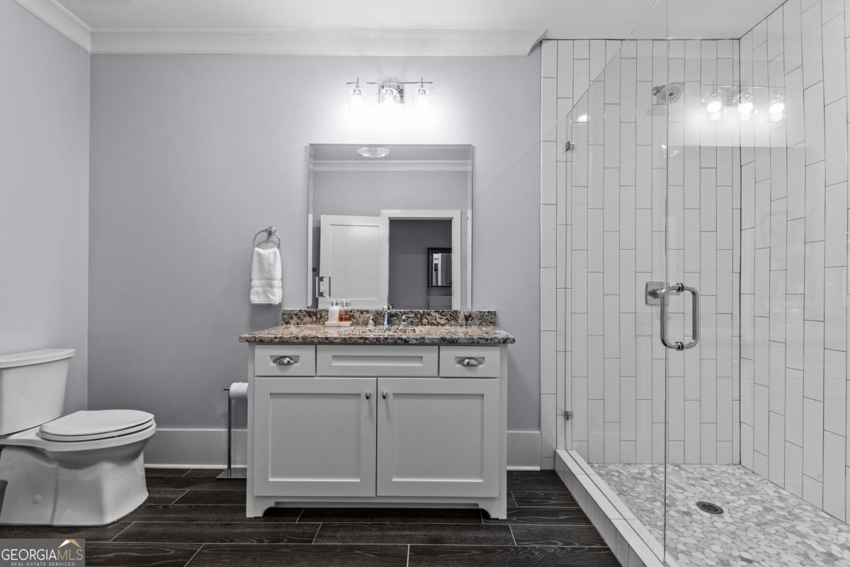 312 Cold Branch Road Eatonton, GA 31024 - Photo 15 of 75 a bathroom with a toilet sink and shower