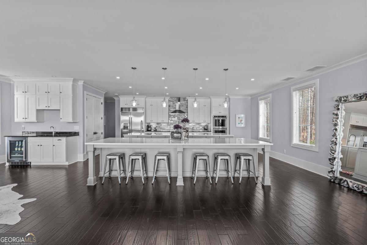 312 Cold Branch Road Eatonton, GA 31024 - Photo 31 of 75 a large white kitchen with lots of counter space wooden floor and appliances