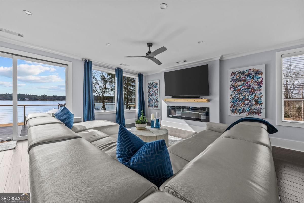 312 Cold Branch Road Eatonton, GA 31024 - Photo 33 of 75 a living room with furniture a large window and a flat screen tv