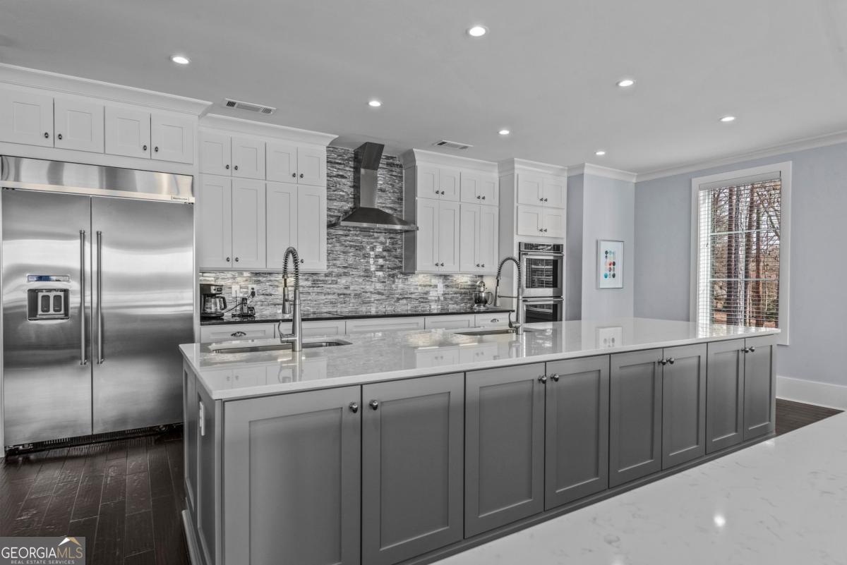 312 Cold Branch Road Eatonton, GA 31024 - Photo 36 of 75 a kitchen with stainless steel appliances granite countertop a sink and a refrigerator