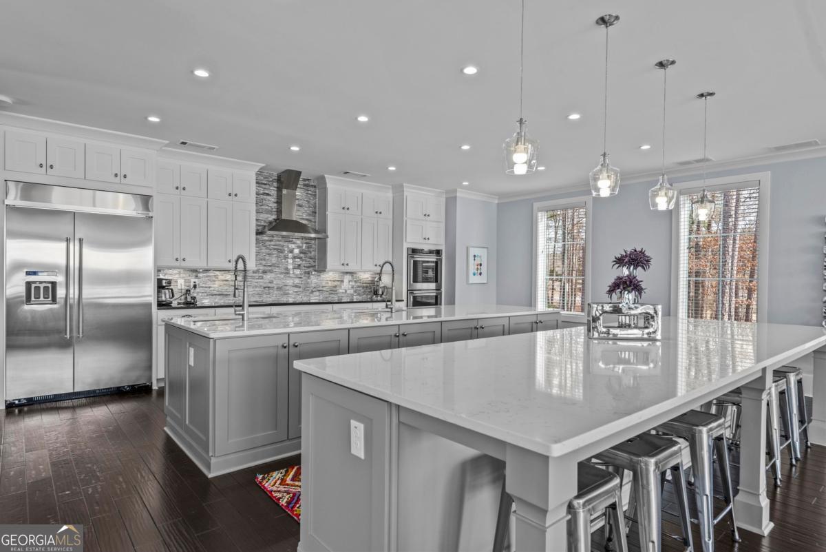 312 Cold Branch Road Eatonton, GA 31024 - Photo 37 of 75 a large kitchen with granite countertop a large counter top a sink stainless steel appliances and cabinets