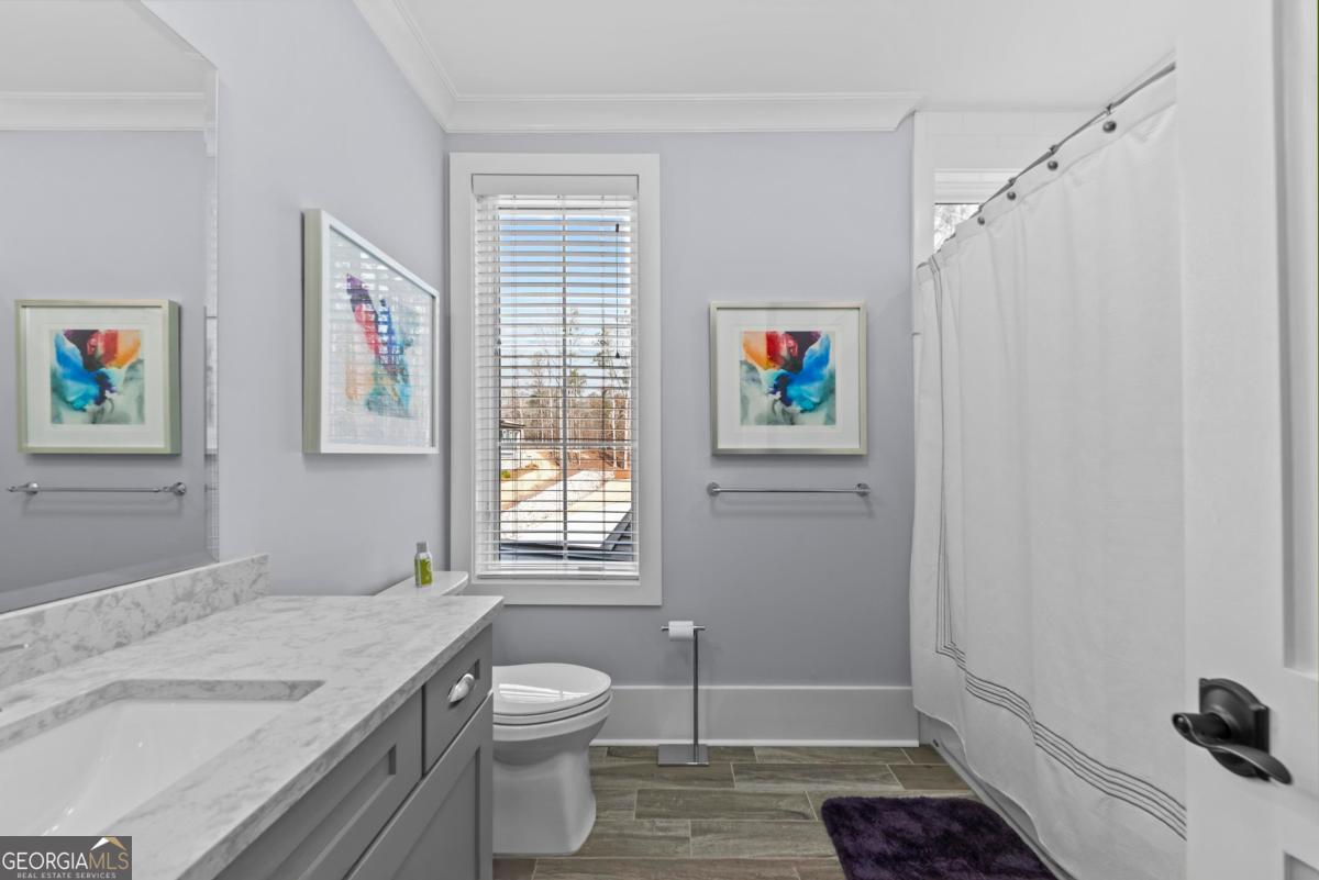 312 Cold Branch Road Eatonton, GA 31024 - Photo 42 of 75 a bathroom with a granite countertop sink a toilet and a shower