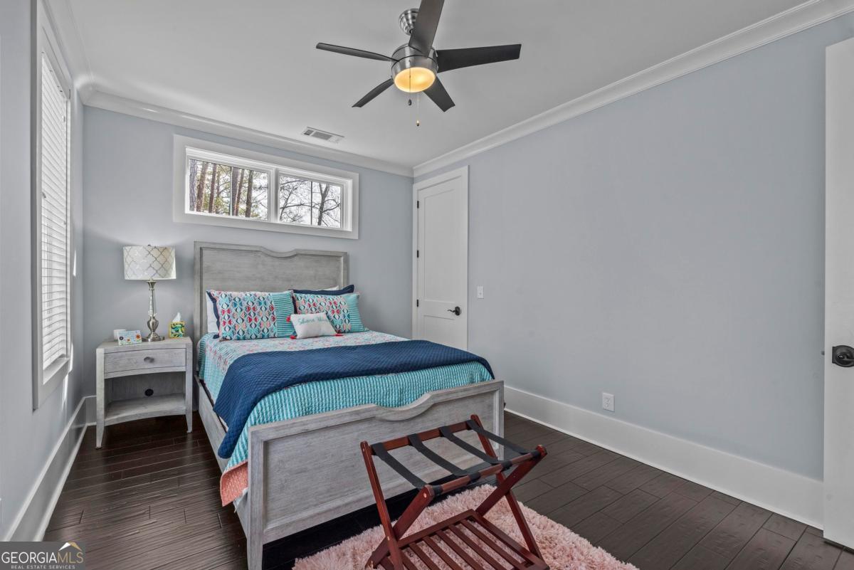 312 Cold Branch Road Eatonton, GA 31024 - Photo 44 of 75 a bedroom with a bed and a chandelier