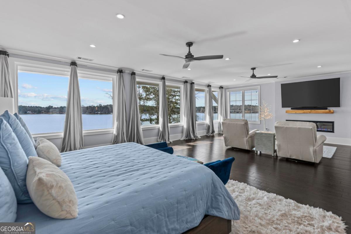 312 Cold Branch Road Eatonton, GA 31024 - Photo 52 of 75 a bedroom with a bed window and a flat screen tv