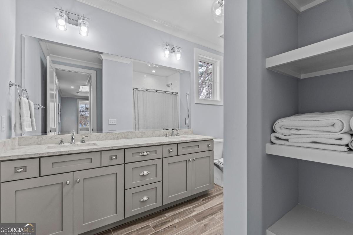 312 Cold Branch Road Eatonton, GA 31024 - Photo 58 of 75 a spacious bathroom with a double vanity sink and a mirror