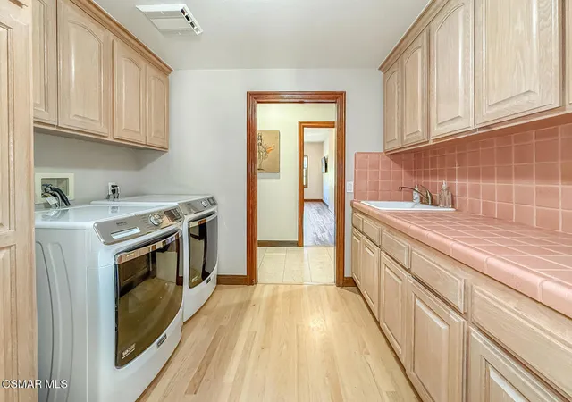 a kitchen with granite countertop a sink a stove and cabinets