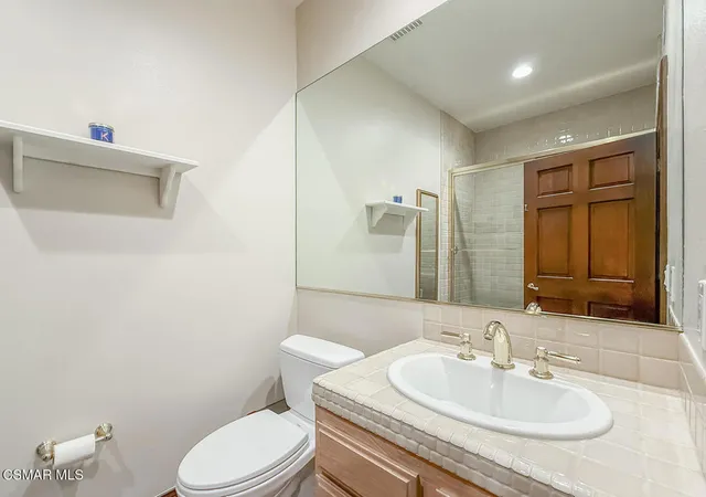 a spacious bedroom with a bed and a chandelier