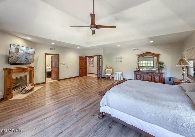 a bathroom with a double vanity sink bathtub and next to a large window