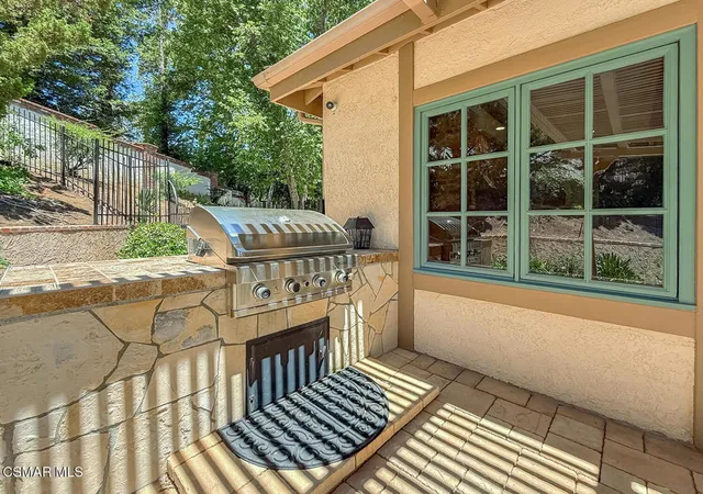 a view of a house with backyard porch and sitting area