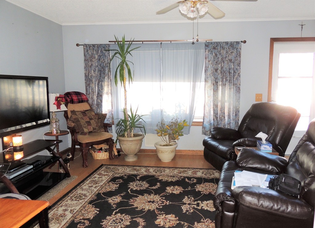 200 Nottingham Street Springfield, MA 01104 - Photo 2 of 14 a living room with furniture and a flat screen tv