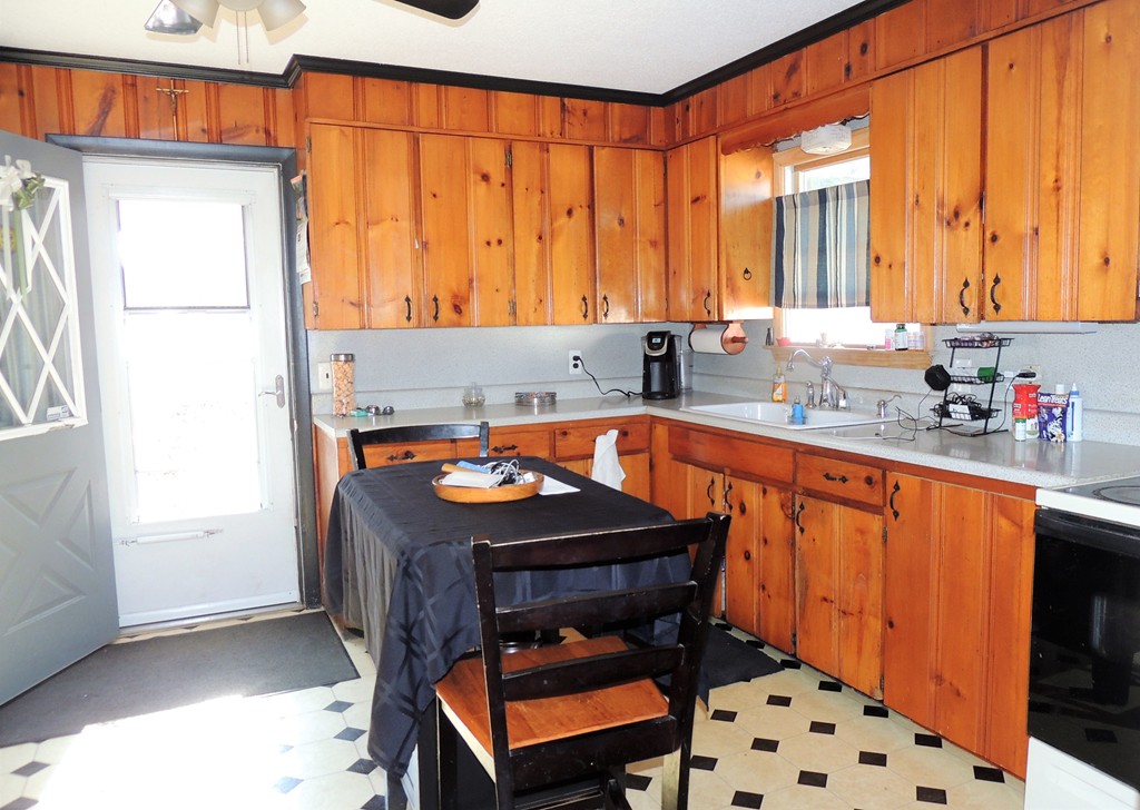 200 Nottingham Street Springfield, MA 01104 - Photo 6 of 14 a kitchen with a sink a counter and a chair