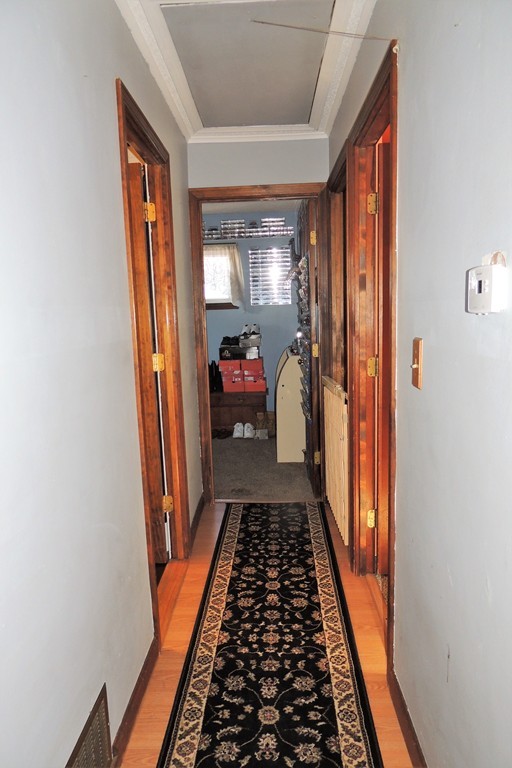 200 Nottingham Street Springfield, MA 01104 - Photo 7 of 14 a hallway with wooden floor and furniture