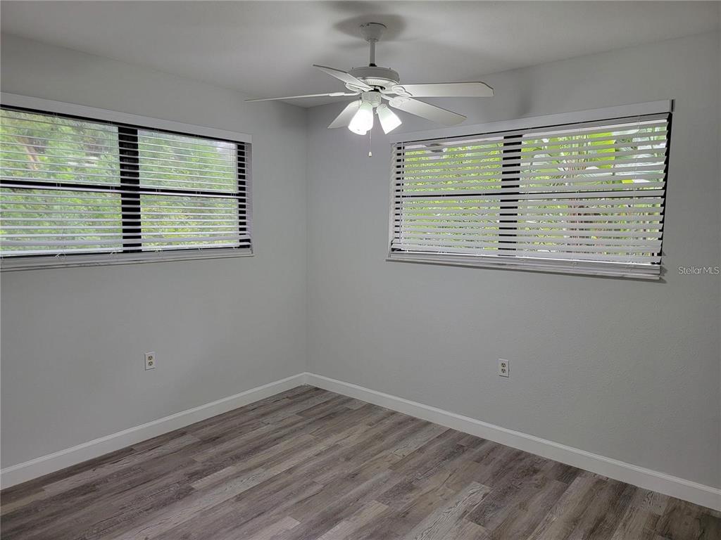 26221 Constantine Road Punta Gorda, FL 33983 - Photo 15 of 27 a view of an empty room with wooden floor and a window