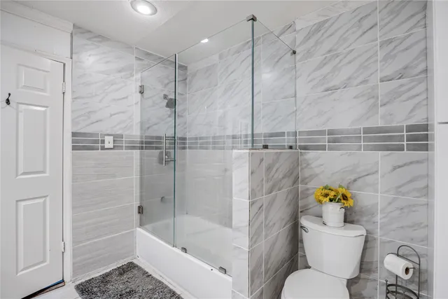 a bathroom with a sink mirror toilet and bathtub