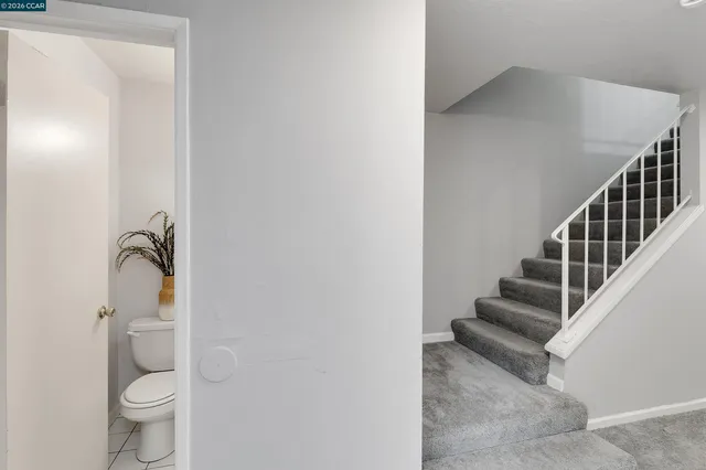 a bathroom with a sink a toilet and mirror