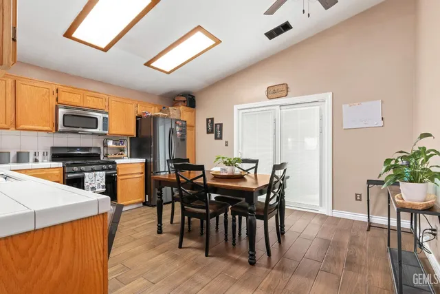 a view of a dining room with furniture and a kitchen