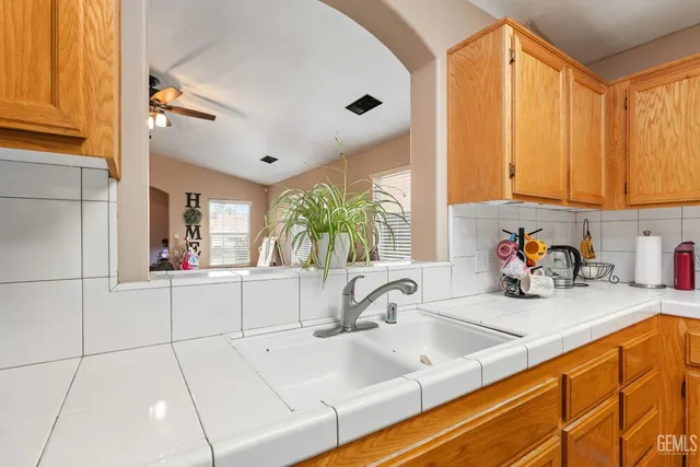 a kitchen with sink a window and cabinets