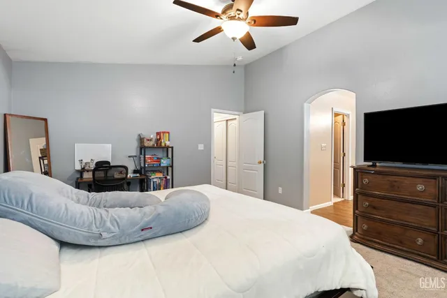 a bedroom with a bed and a flat screen tv