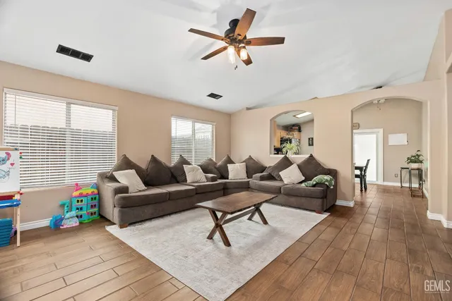a living room with furniture and wooden floor
