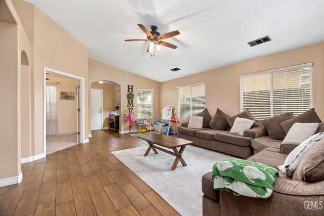 a living room with furniture and wooden floor