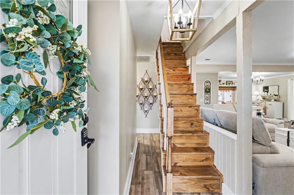 1833 Tom Odum Road Vidalia, GA 30474 - Photo 33 of 59 a view of a hallway with wooden floor and stairs