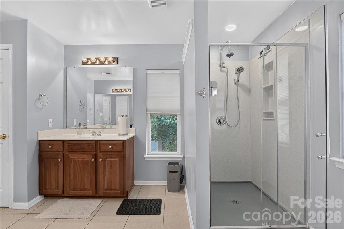 8006 Fine Robe Drive Indian Trail, NC 28079 - Photo 28 of 36 a bathroom with a shower sink and mirror