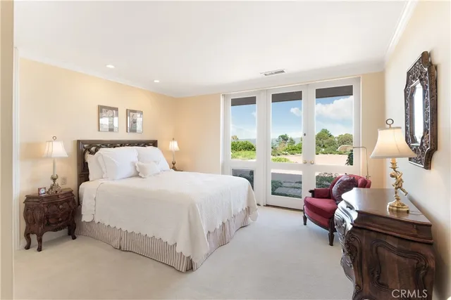 a bedroom with a bed couch and a window