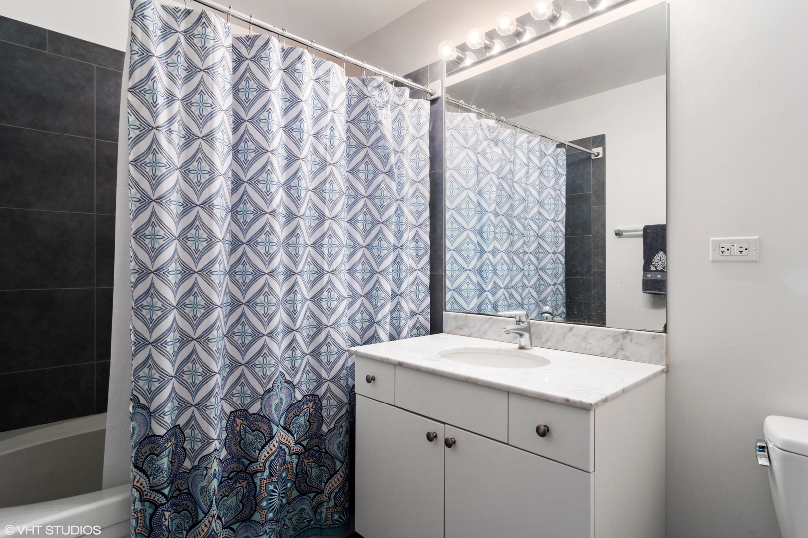 235 West Van Buren Street, Unit 3706 Chicago, IL 60607 - Photo 6 of 13 a bathroom with a sink and a mirror