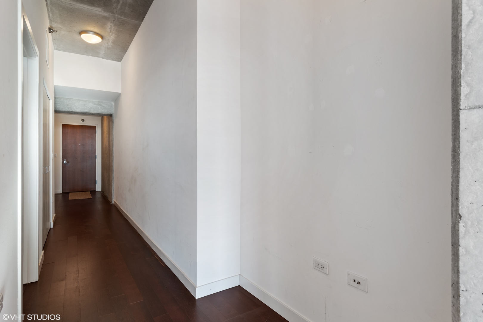 235 West Van Buren Street, Unit 3706 Chicago, IL 60607 - Photo 8 of 13 a view of a hallway with a wooden floor