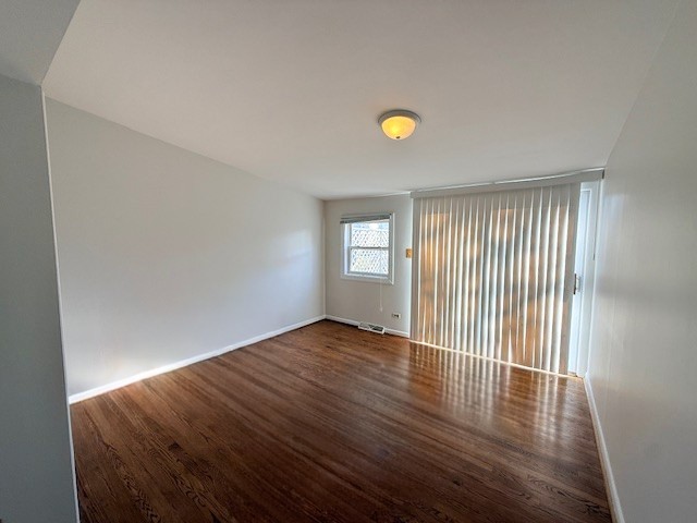363 Maple Street Glen Ellyn, IL 60137 - Photo 6 of 17 a view of an empty room with wooden floor and a window